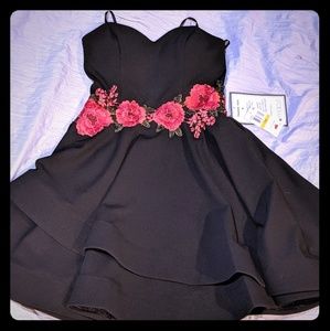 A black strapless dress with rose details